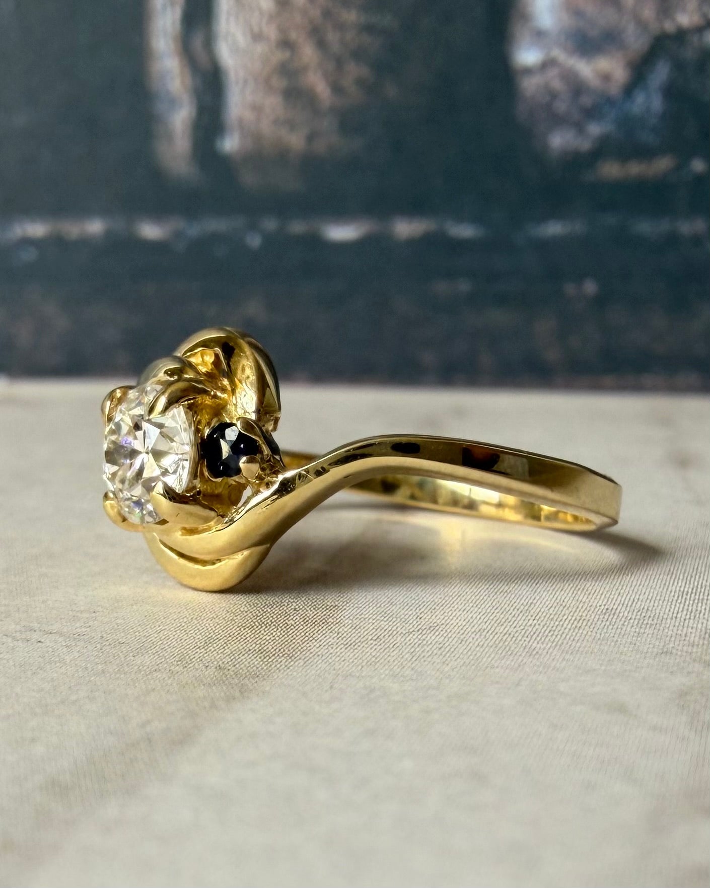 Mid - Century 14k Yellow Gold, Old European Cut Diamond, and Sapphire Bypass Swirl Ring - Clover Collective Antiques