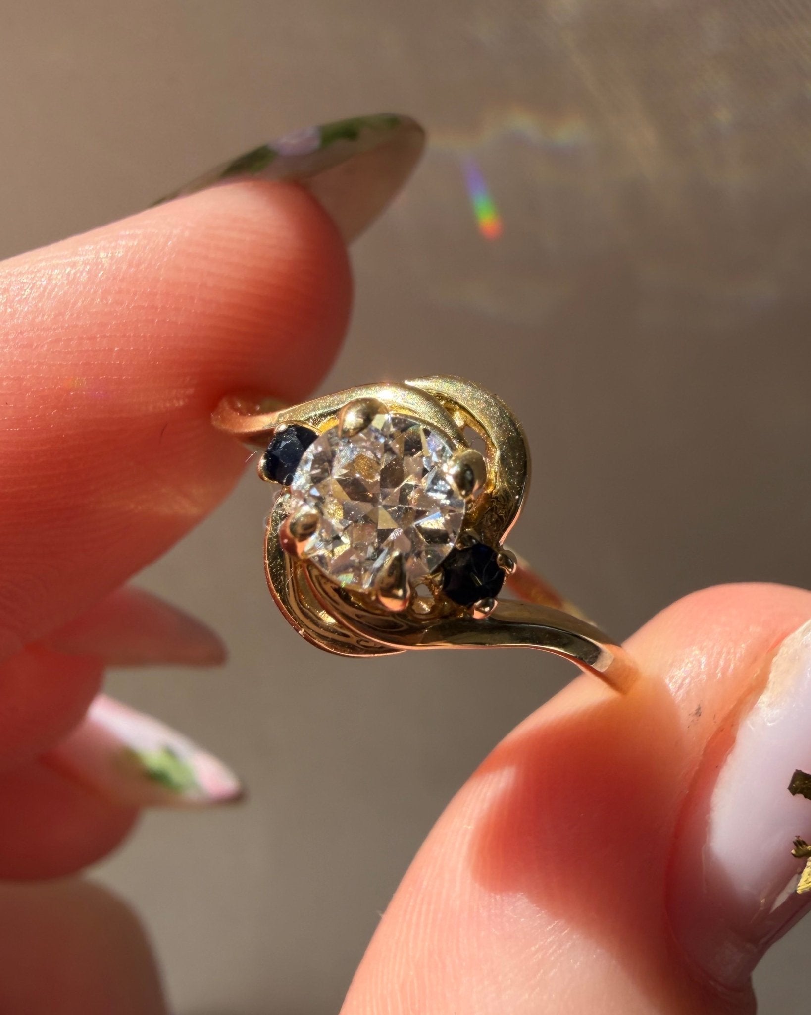 Mid - Century 14k Yellow Gold, Old European Cut Diamond, and Sapphire Bypass Swirl Ring - Clover Collective Antiques