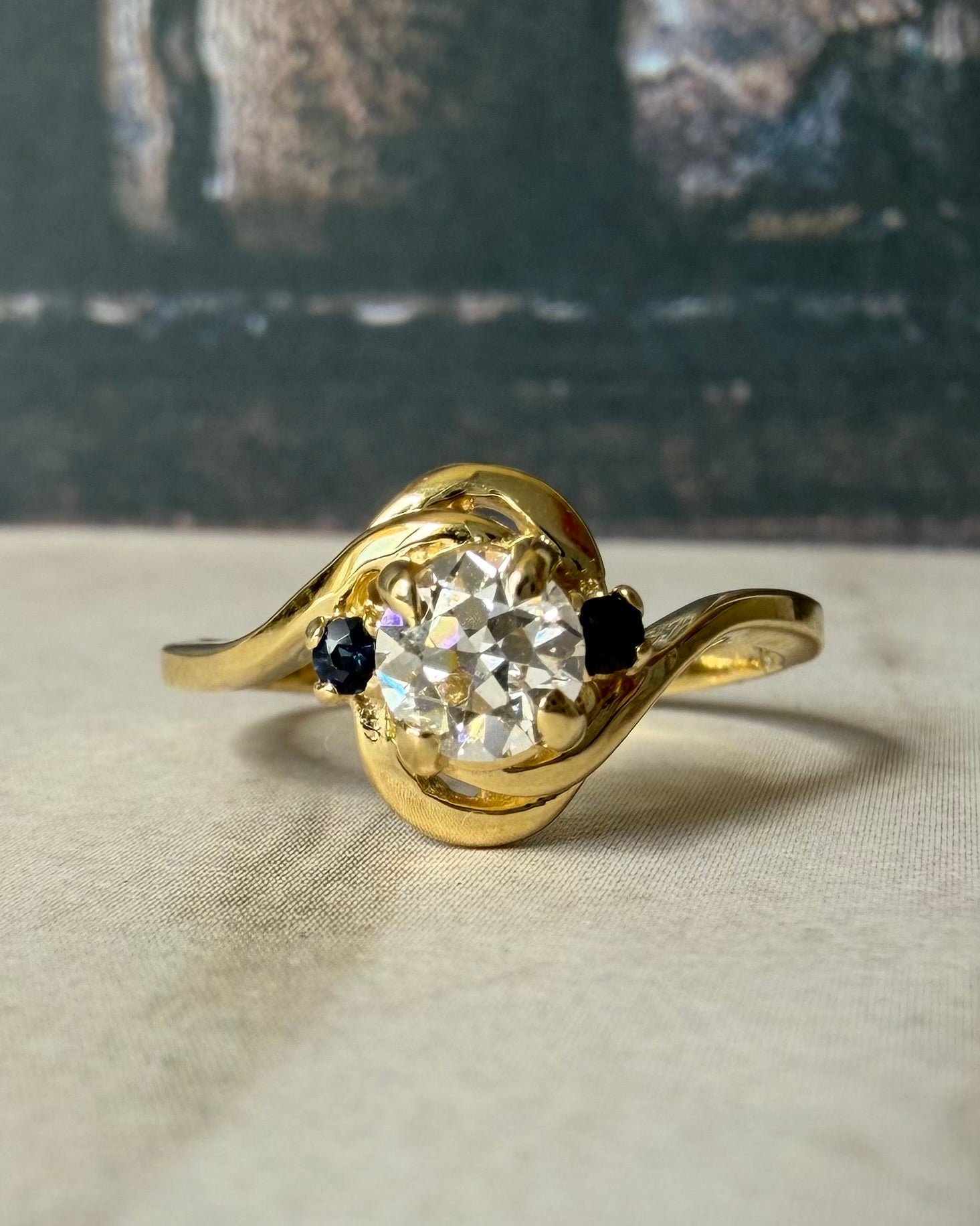 Mid - Century 14k Yellow Gold, Old European Cut Diamond, and Sapphire Bypass Swirl Ring - Clover Collective Antiques