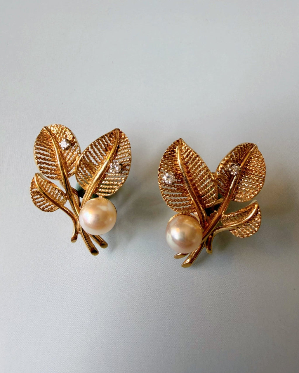 Pair of Mid Century 14k Yellow Gold, Pearl, and Diamond Flora Leaf Ear Clip Earrings - Clover Collective Antiques