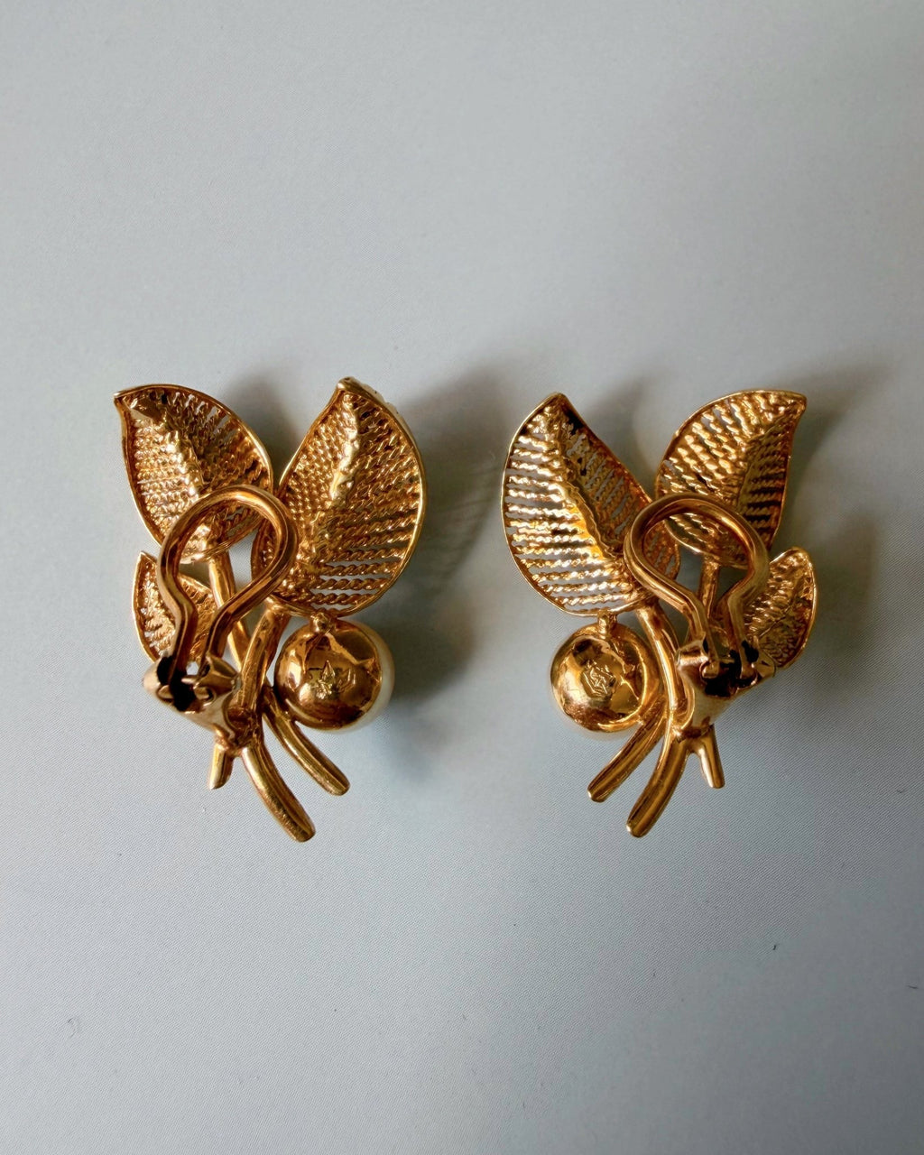 Pair of Mid Century 14k Yellow Gold, Pearl, and Diamond Flora Leaf Ear Clip Earrings - Clover Collective Antiques